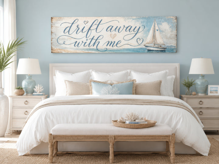 Coastal bedroom wall art featuring a sailboat and 'Drift away with me' text on light blue canvas.