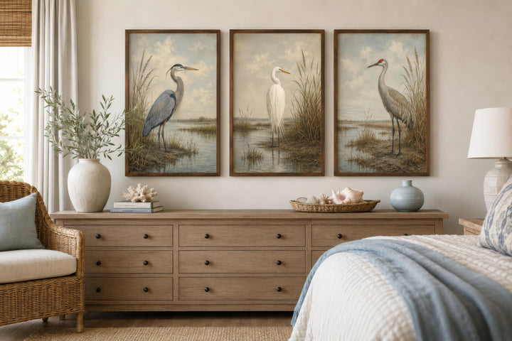 Set of three vintage-style coastal bird canvas prints featuring a heron, egret, and crane in frames.