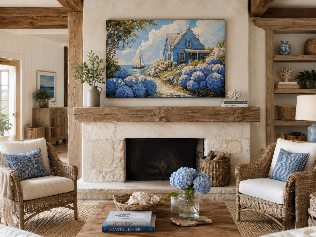 Coastal canvas print of a blue cottage and sailboat above a rustic stone fireplace.