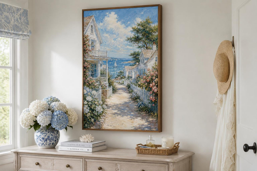 Vertical canvas print of a coastal cottage painting with a path leading to a blue sea.