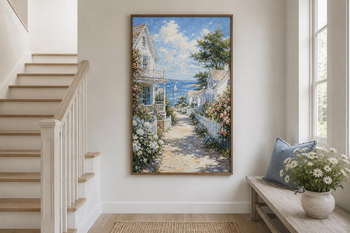 Vertical canvas print of a coastal cottage path with white houses, flowers, and a sailboat at sea.