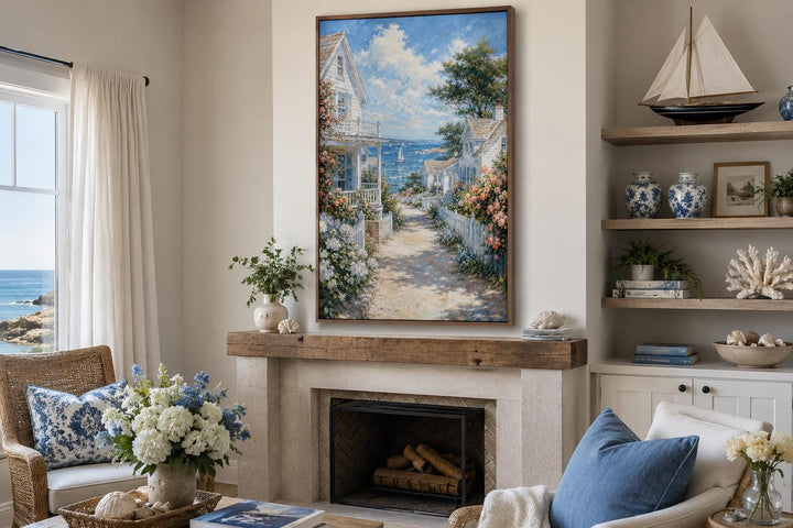 Vertical canvas print of a coastal cottage path leading to the sea, hung above a fireplace mantle.