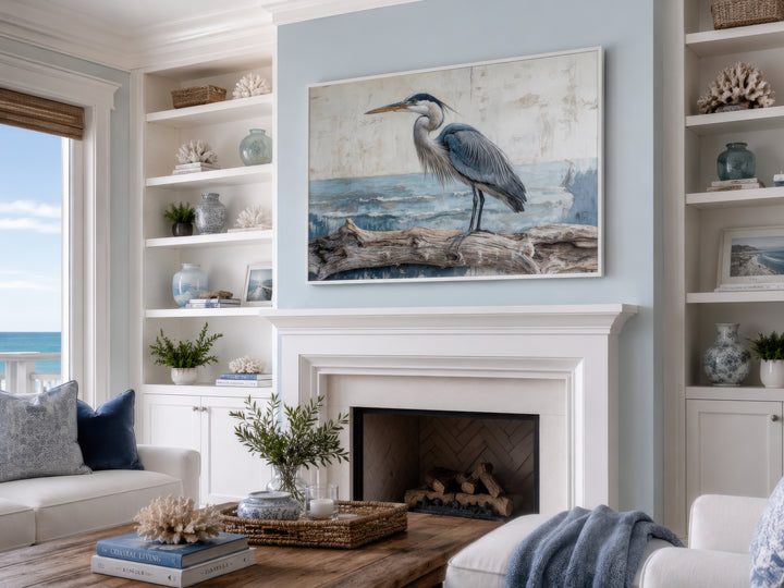 Coastal Heron on Driftwood canvas wall art above a white fireplace in a serene living room.