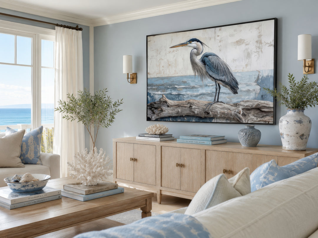 Coastal heron on driftwood canvas wall art in a serene blue and neutral living room.