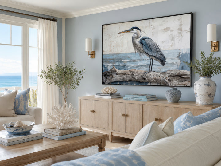 Coastal heron on driftwood canvas wall art in a serene blue and neutral living room.