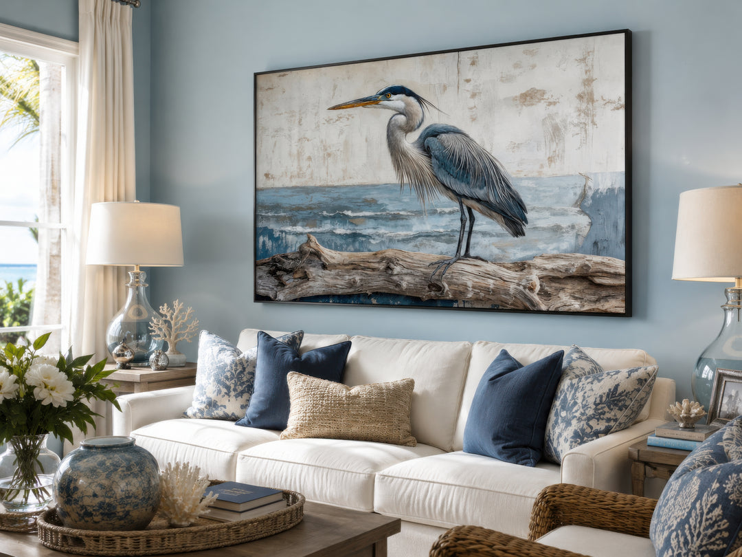 Coastal Heron on Driftwood canvas wall art in a serene blue living room with a white sofa.