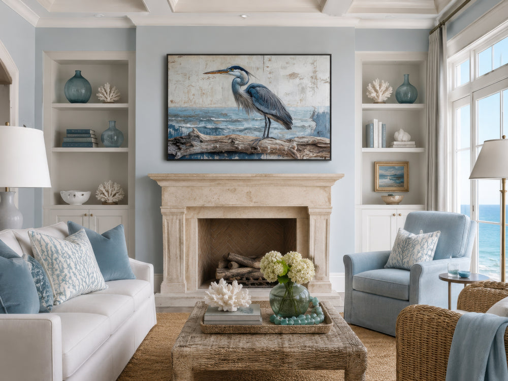 Coastal Heron on Driftwood canvas print hanging above a fireplace in a serene blue living room.