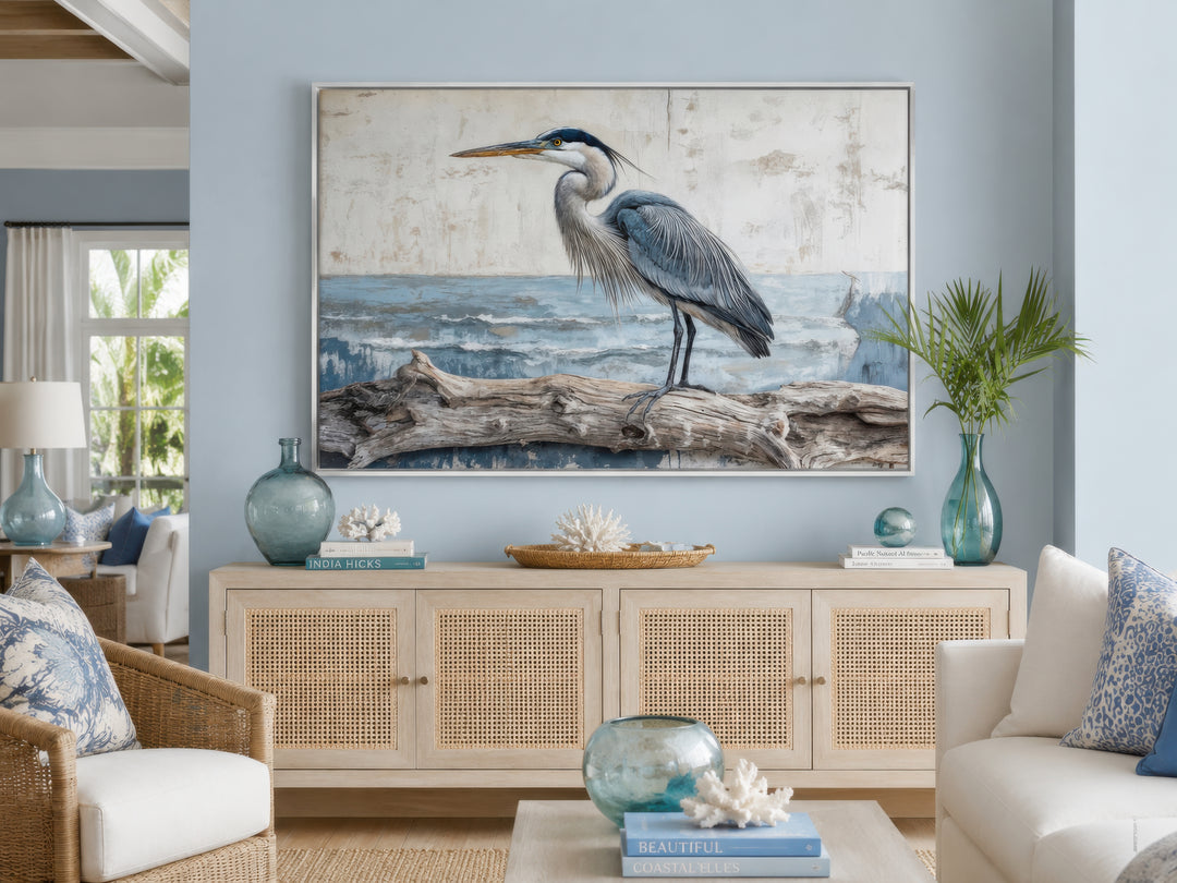 Coastal heron on driftwood canvas print in a serene living room with light wood furniture.