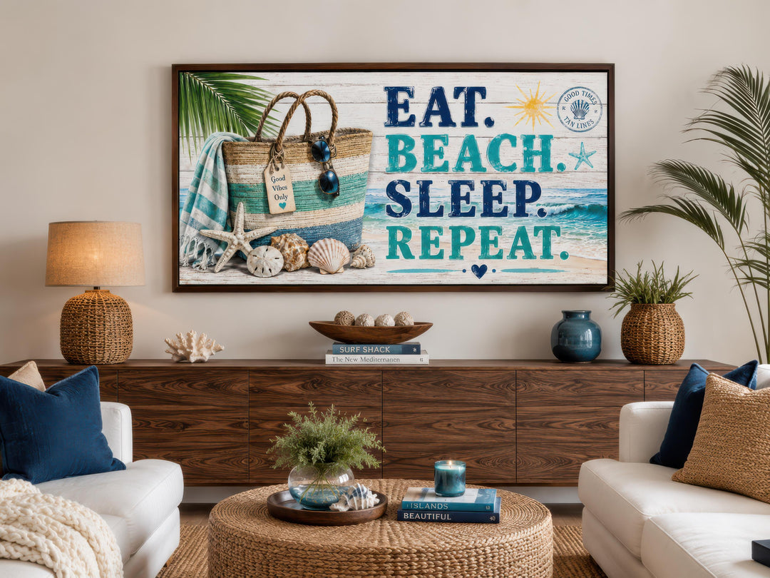 Coastal wall art featuring 'Eat Beach Sleep Repeat' text on a beach-themed canvas above a sideboard.