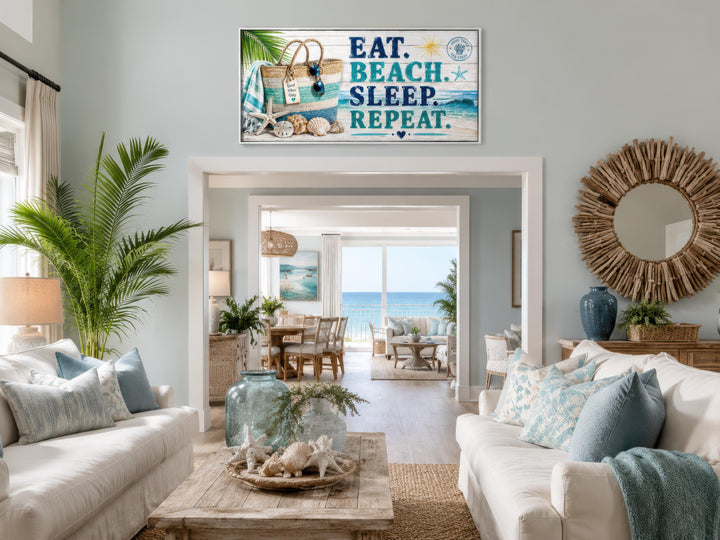 Coastal wall art canvas print with "Eat. Beach. Sleep. Repeat." text in a beach house living room.