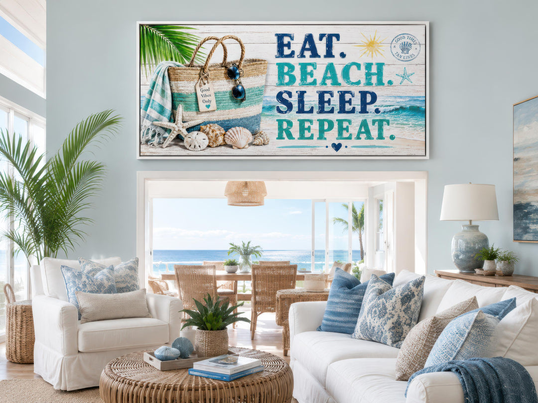 Eat Beach Sleep Repeat canvas wall art above a white sofa in a coastal living room.