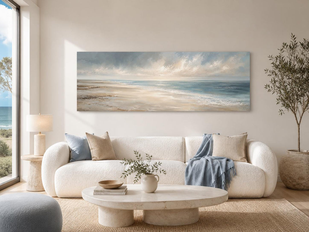 Long horizontal coastal wall art canvas of a calm ocean seascape with soft clouds and gentle waves.