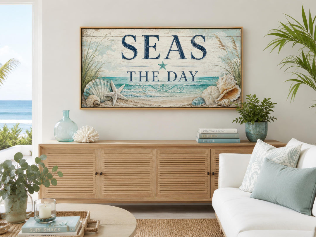 Coastal wall art with "Seas the Day" text and seashell illustrations above a wooden sideboard.