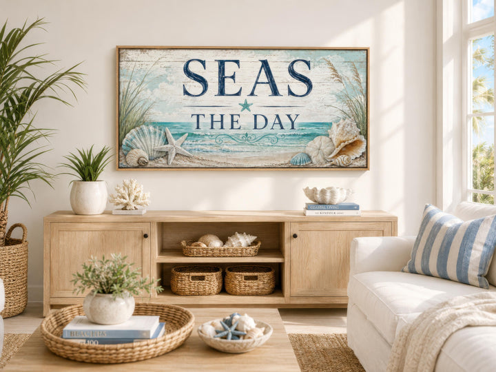 Coastal wall art canvas print with 'Seas the Day' text, starfish, and seashells in a beach house.