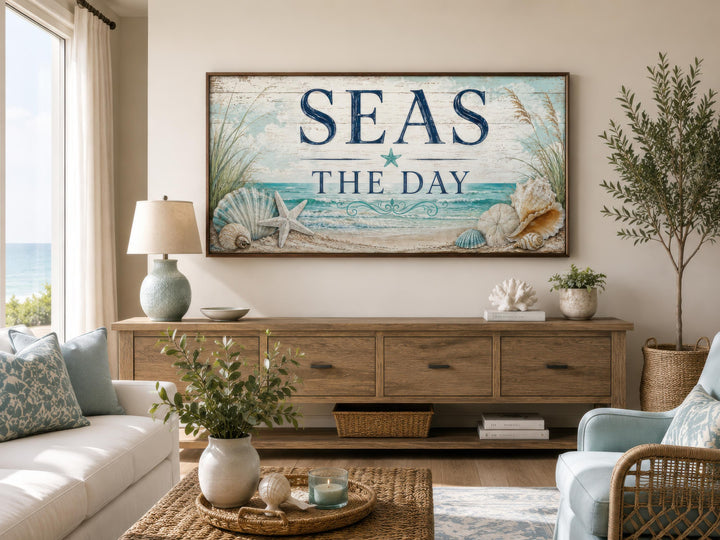 Coastal wall art with "Seas the Day" text, starfish, and seashells above a wooden sideboard.