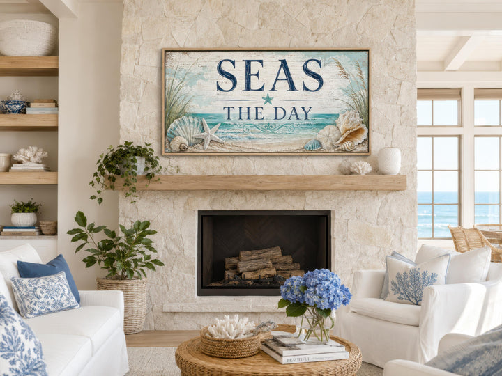 Seas the Day coastal wall art canvas print above a stone fireplace in a beach house living room.