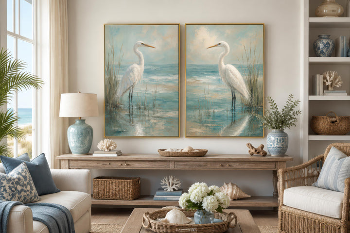 Set of two vertical canvas paintings featuring white egrets in a blue-teal coastal marsh.