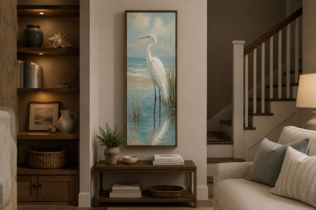 Tall narrow vertical canvas print of a white egret in teal coastal water on a neutral living wall.