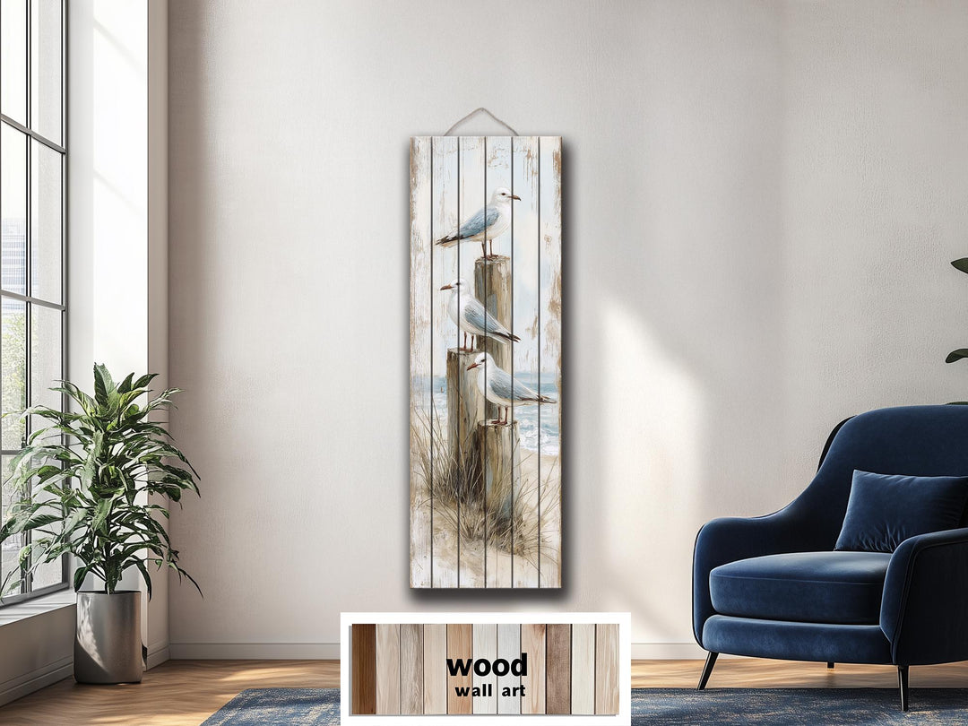 Tall narrow coastal wood wall art featuring seagulls on posts in a distressed beach scene.