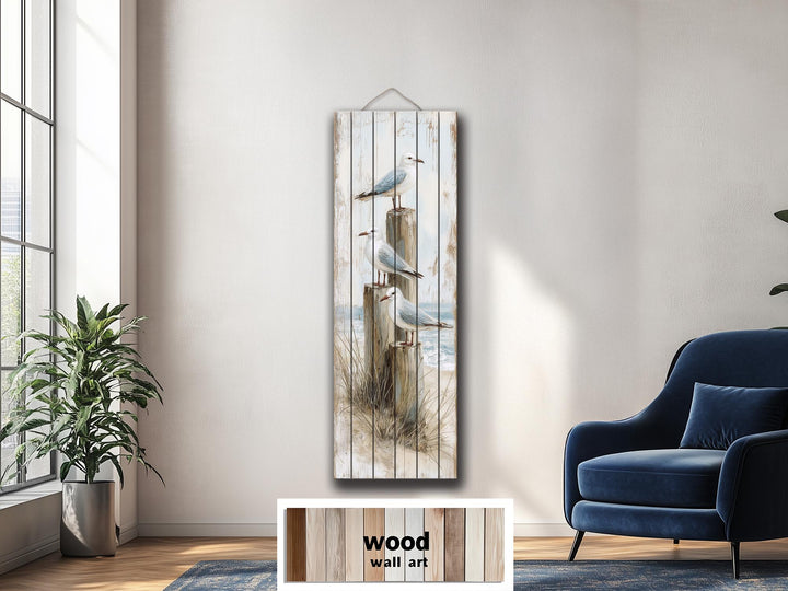 Tall narrow coastal wood wall art featuring seagulls on posts in a distressed beach scene.