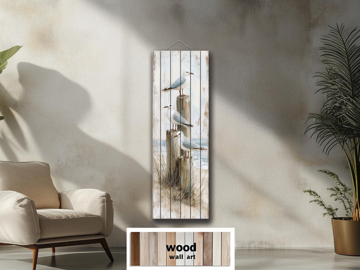Tall narrow coastal wood wall art featuring seagulls perched on posts with a distressed beach print.