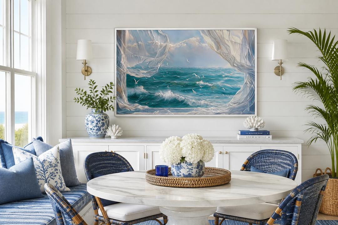 Ocean view framed canvas wall art with seagulls and white curtains in a coastal dining room.