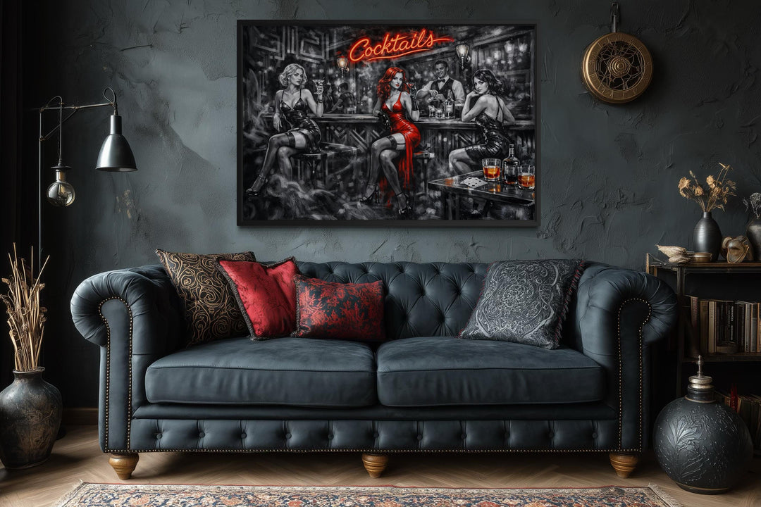 A cinematic noir canvas print of a cocktail bar scene hangs above a dark tufted leather sofa.