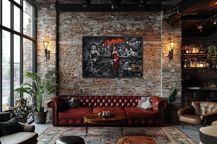 A framed noir-style canvas print of a cocktail bar with selective red accents hangs in a loft.
