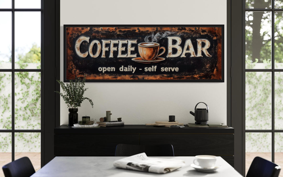 A framed canvas wall art featuring a "Coffee Bar" sign with a steaming cup and "open daily - self serve" text.