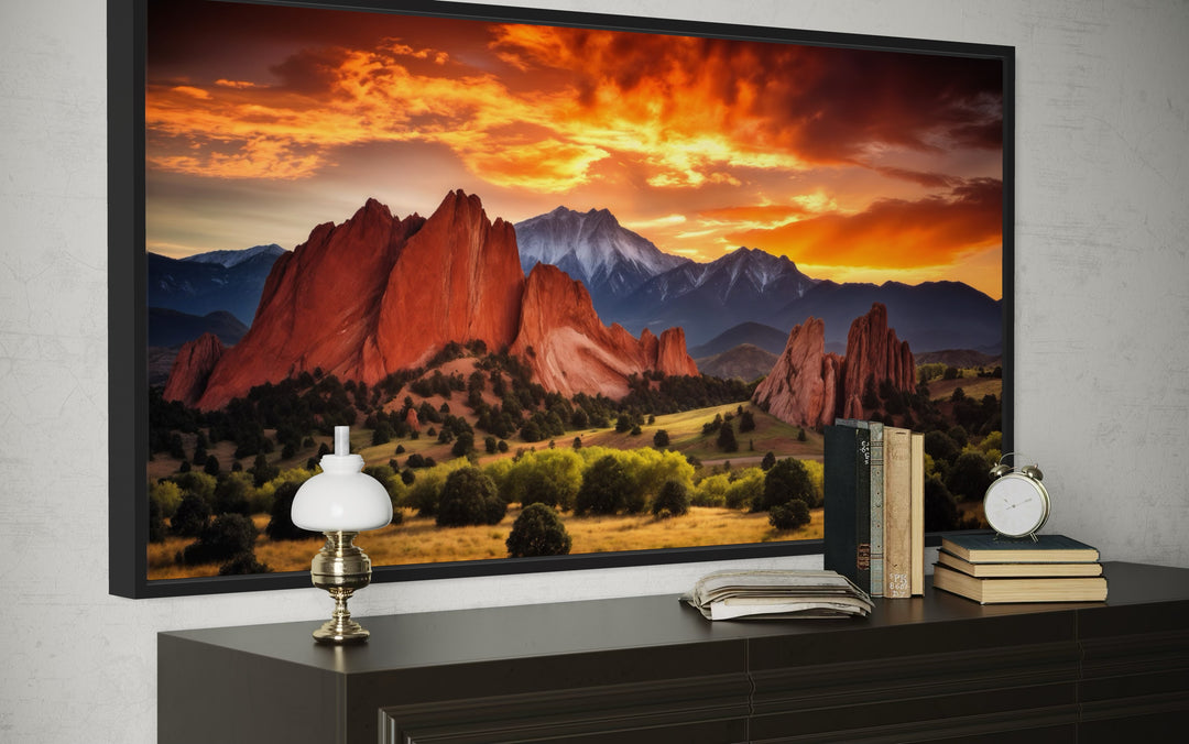 Colorado canvas wall art of Pikes Peak and Garden of the Gods at sunset above a dark wood dresser.