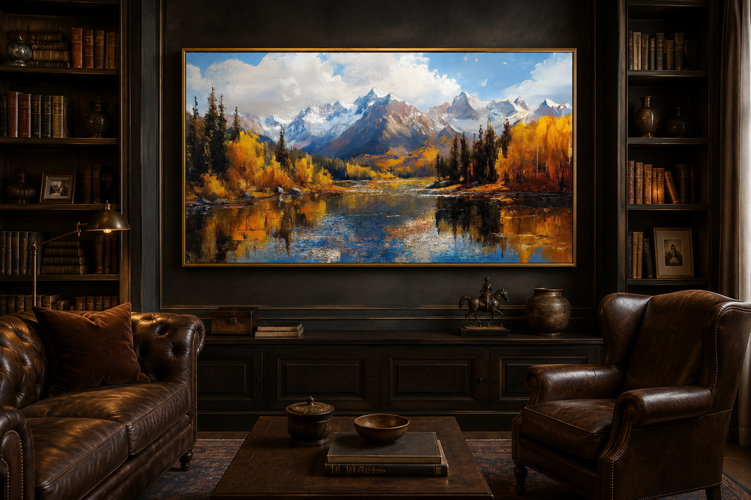 Framed canvas painting of the Colorado Rocky Mountains in autumn above a dark wood console table.