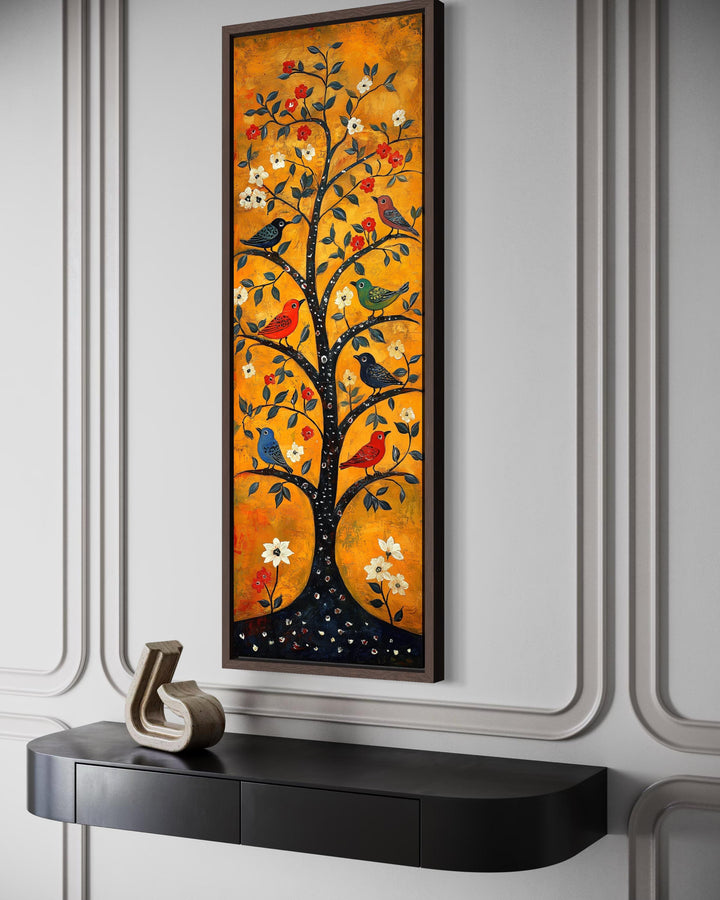 Tall narrow vertical folk art canvas print of colorful birds in a tree on a warm orange background.