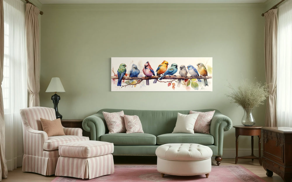 Colorful Birds On A Branch Horizontal Framed Canvas Wall Art displayed above a green sofa.