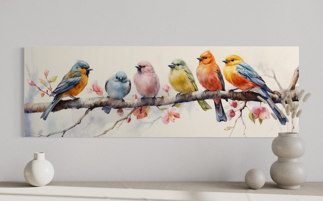 Long horizontal wall art featuring six colorful watercolor birds perched on a flowering branch.
