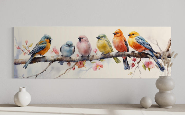 Long horizontal wall art featuring six colorful watercolor birds perched on a flowering branch.