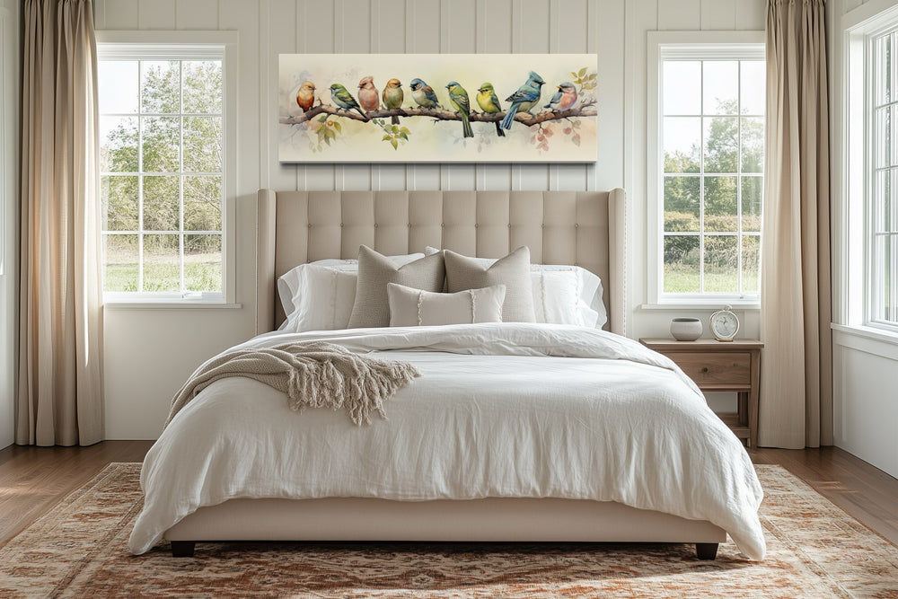 Colorful Birds On a Branch Horizontal Framed Canvas Wall Art hanging above a bed in a bedroom.