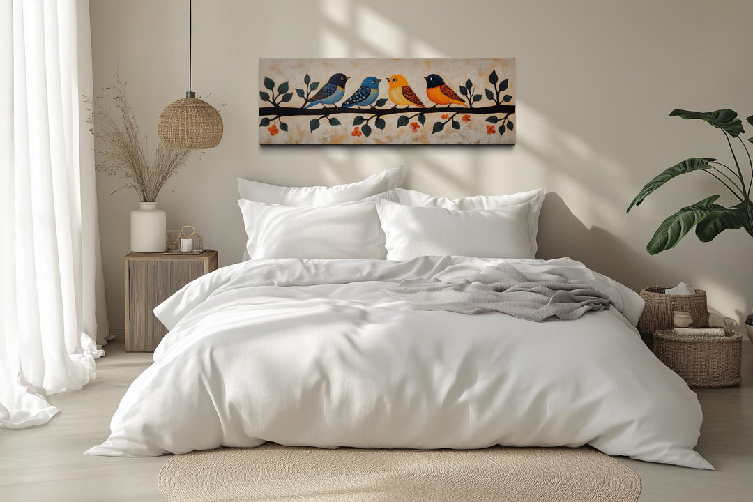 Long narrow folk style canvas print of colorful birds on a branch above a white bed.