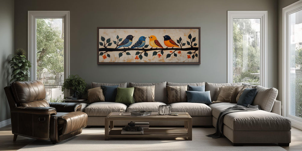 Folk style long narrow canvas print of four colorful birds on a branch above a living room sofa.