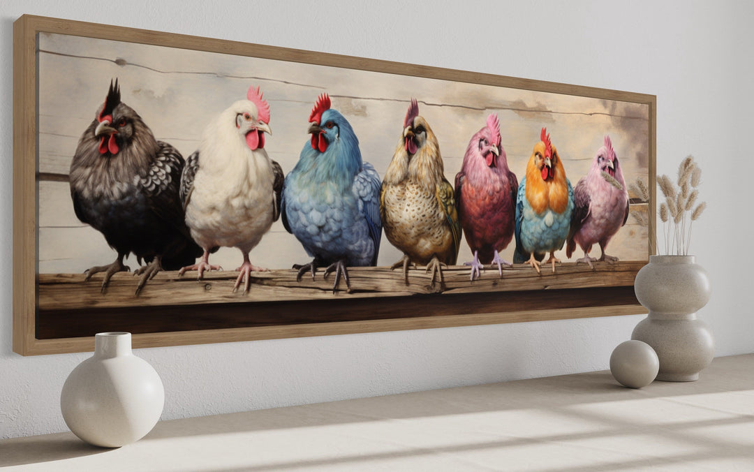 Panoramic framed canvas art of seven colorful chickens perched on a rustic wooden fence.