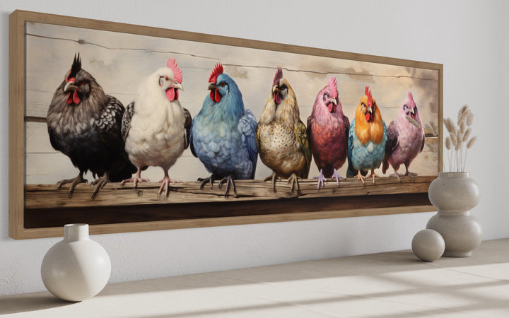 Panoramic framed canvas art of seven colorful chickens perched on a rustic wooden fence.