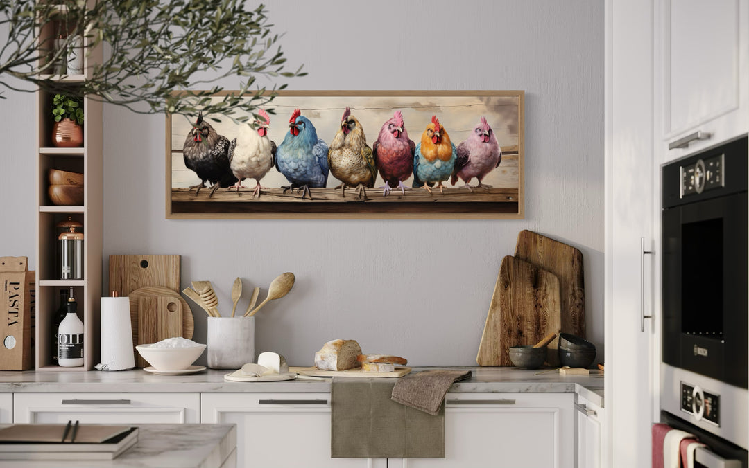 Panoramic framed canvas wall art of seven colorful chickens perched on a rustic wooden fence.