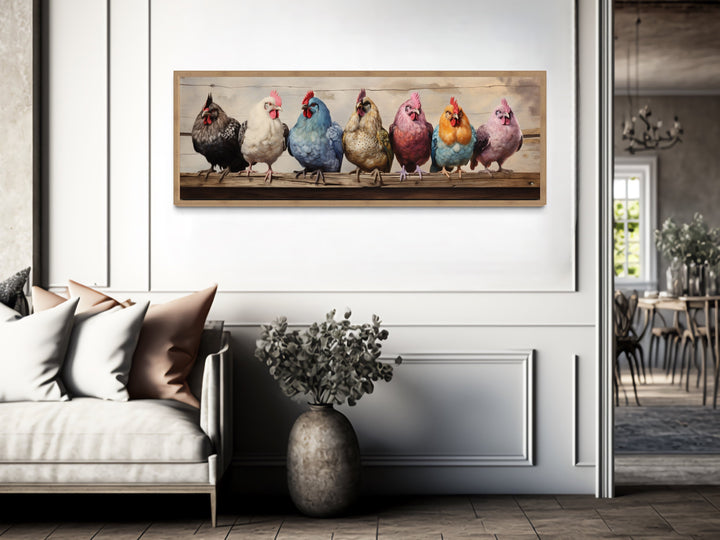 Panoramic framed canvas wall art of seven colorful chickens perched on a rustic wooden fence.
