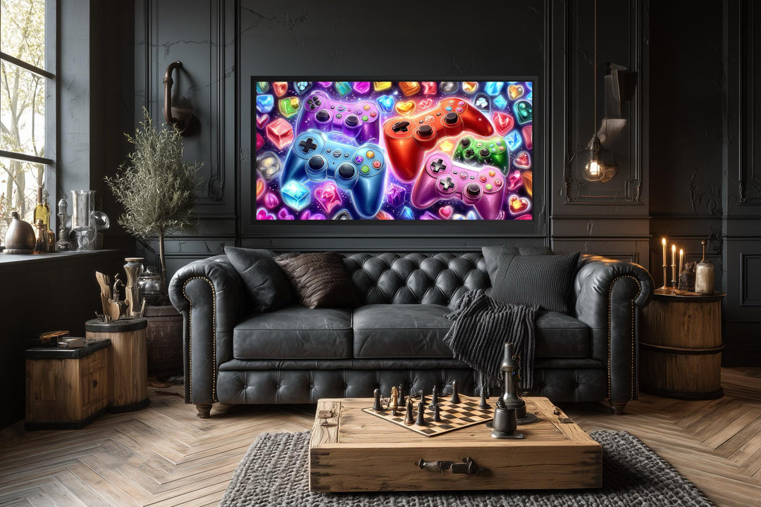 Colorful game controllers canvas wall art displayed above a black leather sofa in a dark room.
