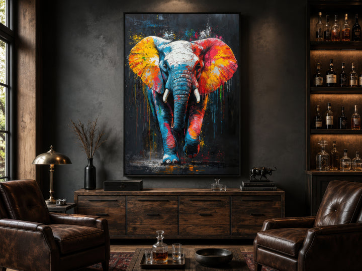 Colorful graffiti elephant framed canvas wall art hanging in a modern dark-toned living room.