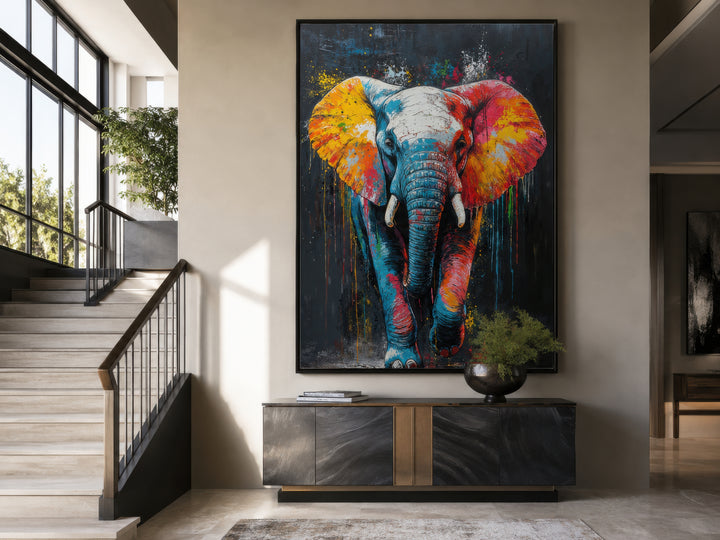 Large framed canvas wall art featuring a colorful graffiti-style elephant in a modern living room.