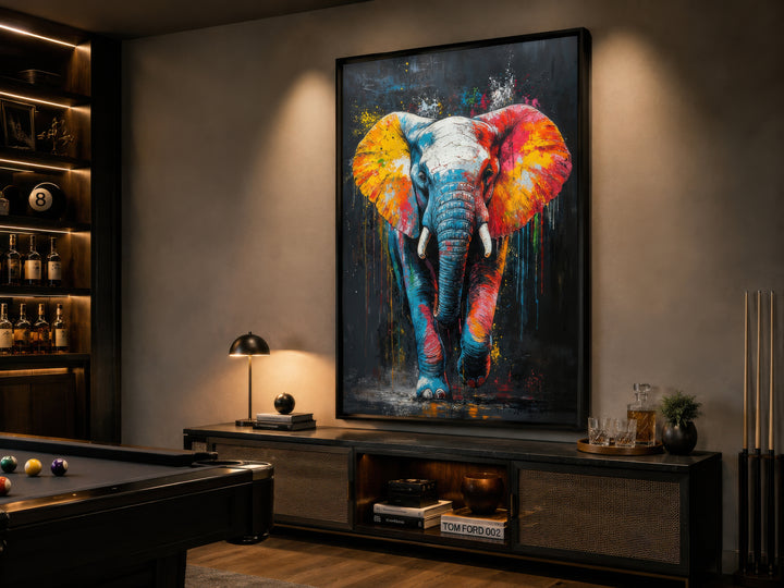 Colorful graffiti elephant framed canvas wall art hanging in a modern game room above a console.