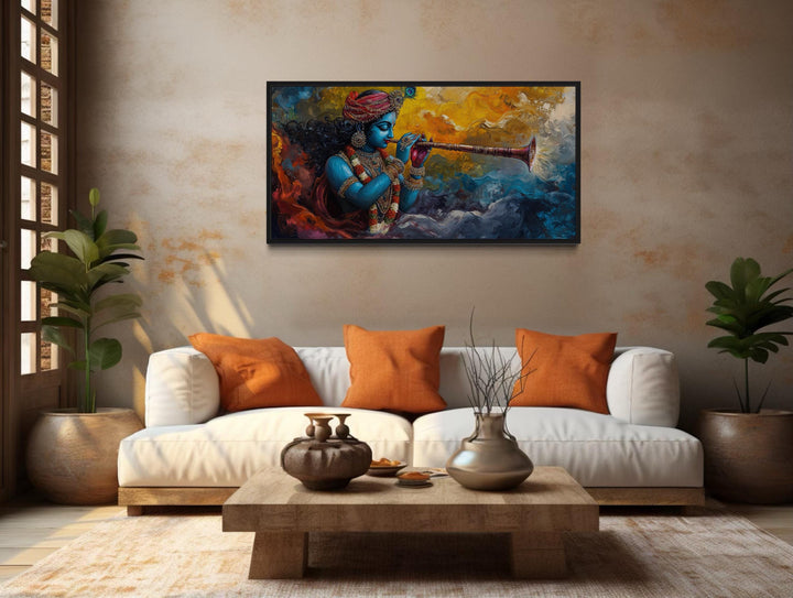 Colorful Krishna playing flute framed horizontal canvas wall art above a white sofa in a living room