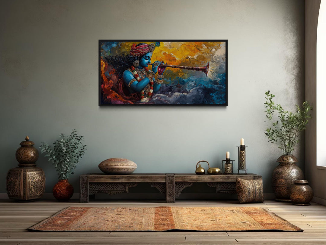 Framed horizontal canvas wall art of colorful Krishna playing a flute in a serene room setting.