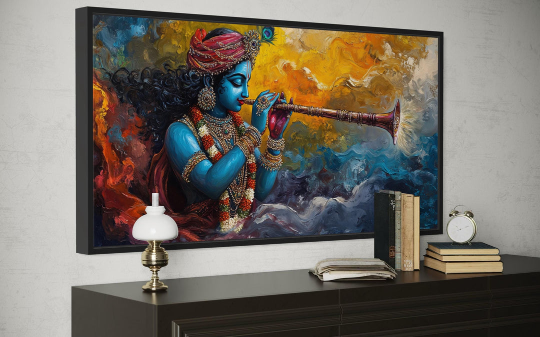 Colorful Krishna playing flute framed horizontal canvas wall art above a dark wood dresser.