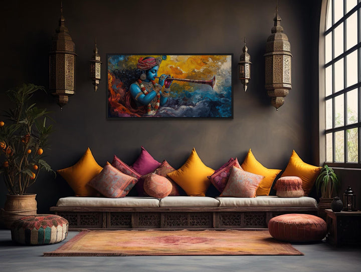 Colorful Krishna playing flute framed horizontal canvas wall art in a bohemian living room.